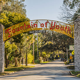 Red sign on yellow background for historic Fountain of Youth in St. Augustine Florida