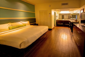 king bed suite with view of bathroom vanity